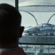 Benoit Blanc, played by Daniel Craig, looks at Miles Bron's Porsche 918 Spyder in Glass Onion: A Knives Out Story